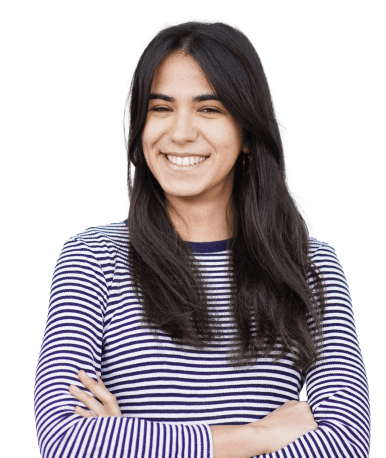 Happy young woman with dark hair, wearing a striped shirt, arms crossed.