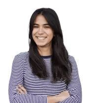 Happy young woman with dark hair, wearing a striped shirt, arms crossed.